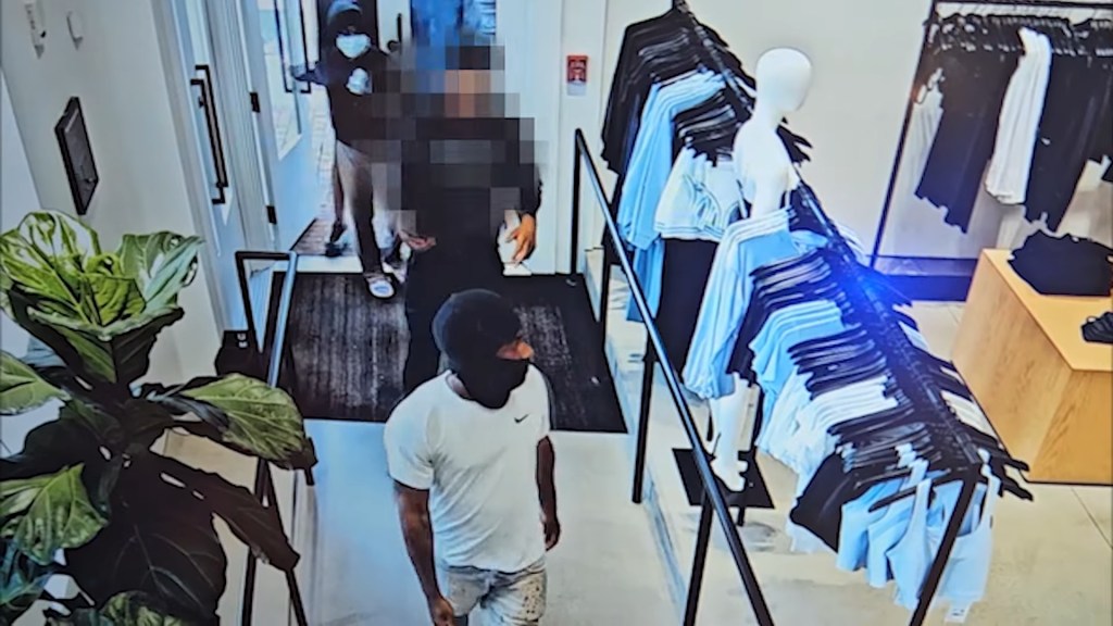 Police released surveillance video showing six masked suspects who are wanted in connection with the retail theft.