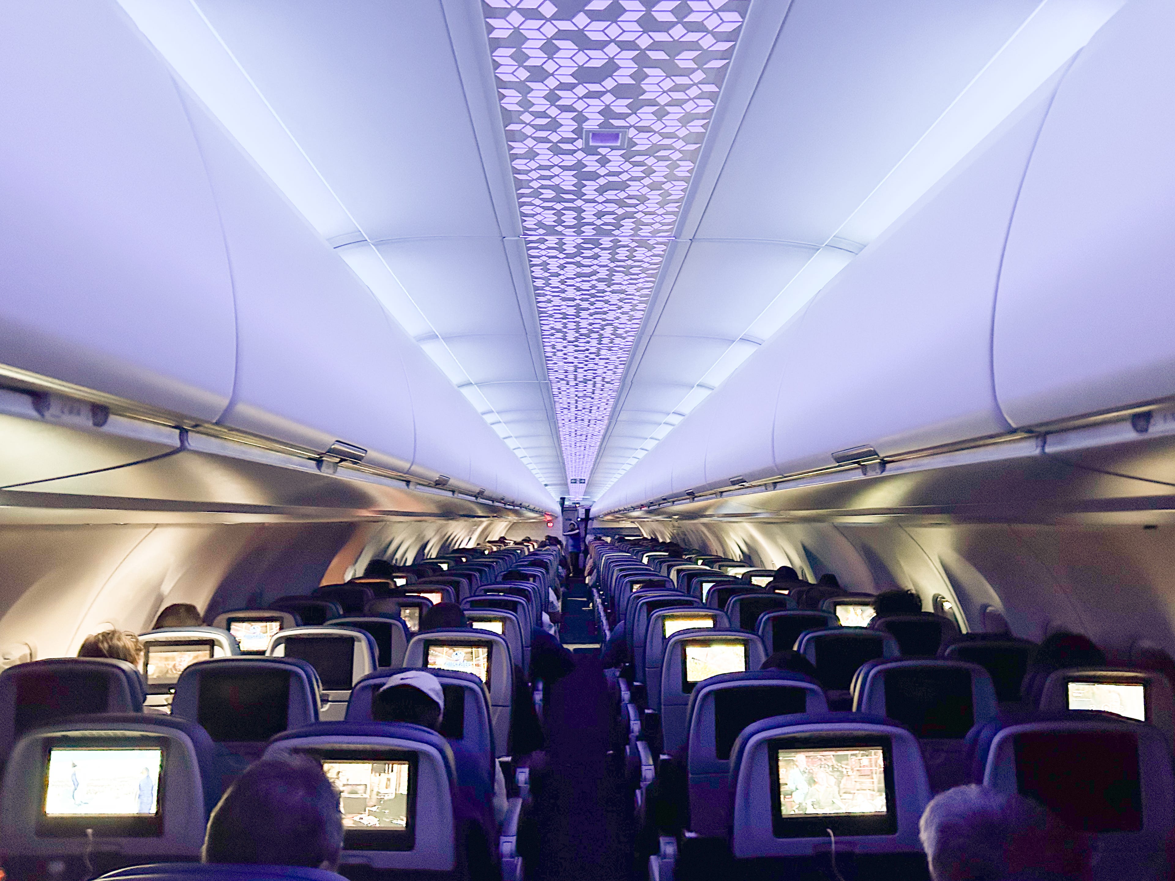 A wide view of an airplane cabin at night