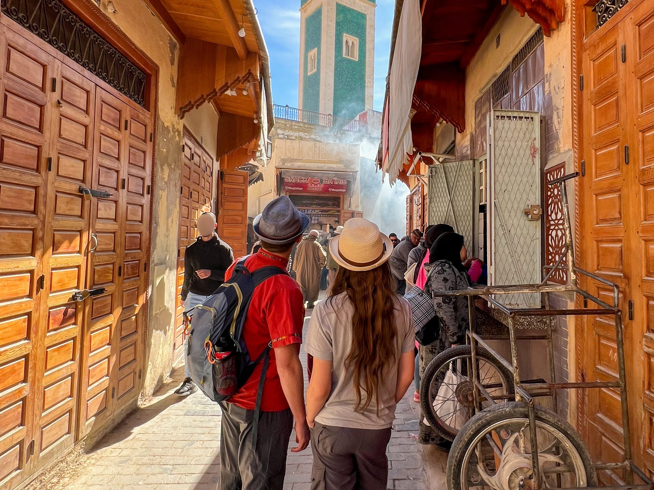 People walk through an alleyway in Meknes, Morocco.
