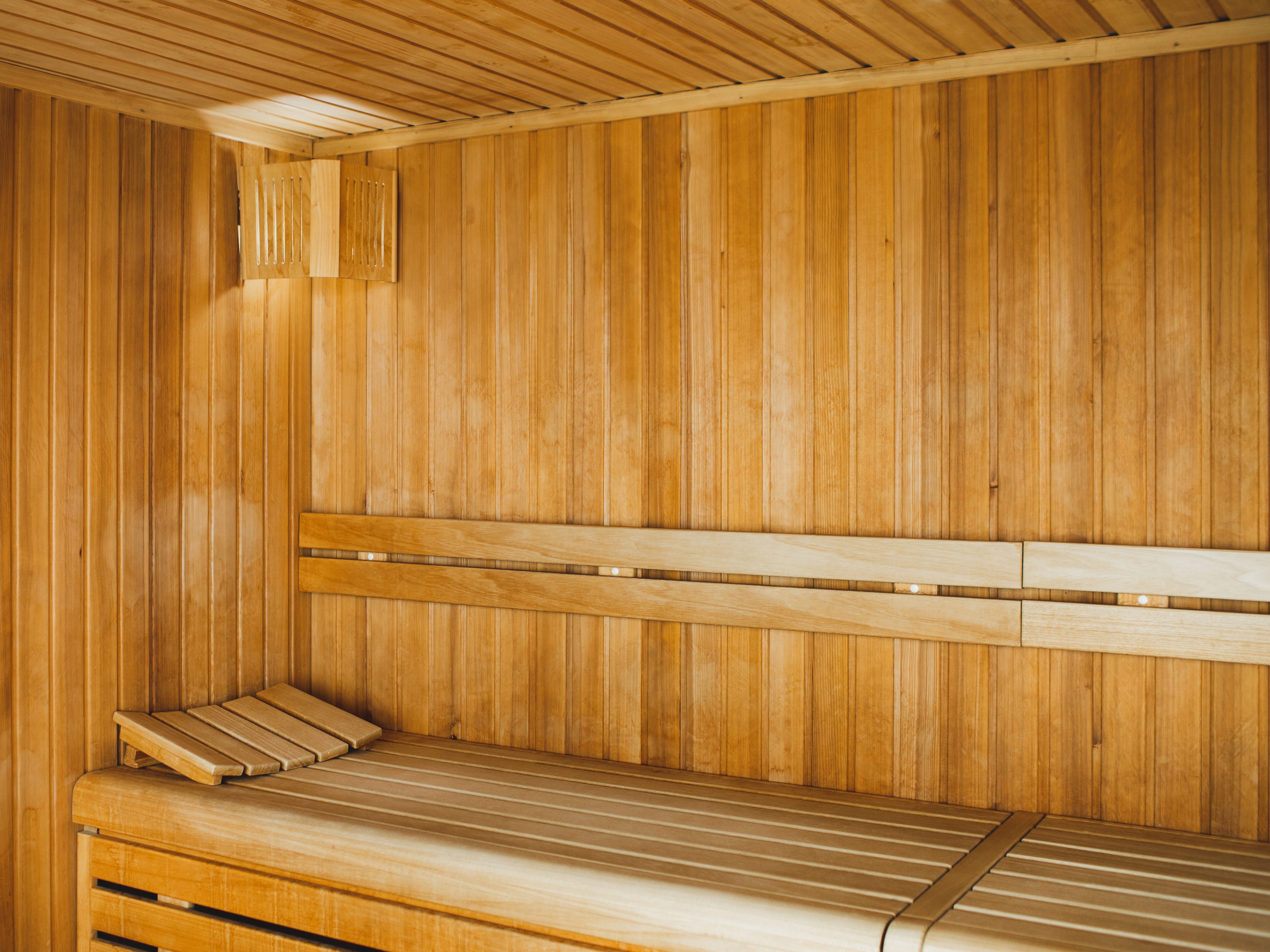 A wooden sauna with a bench.