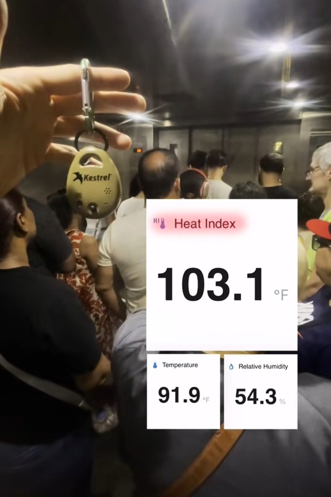 Heat index of 103.1°F, temperature of 91.9°F, and relative humidity of 54.3% displayed on a device in a crowded elevator.