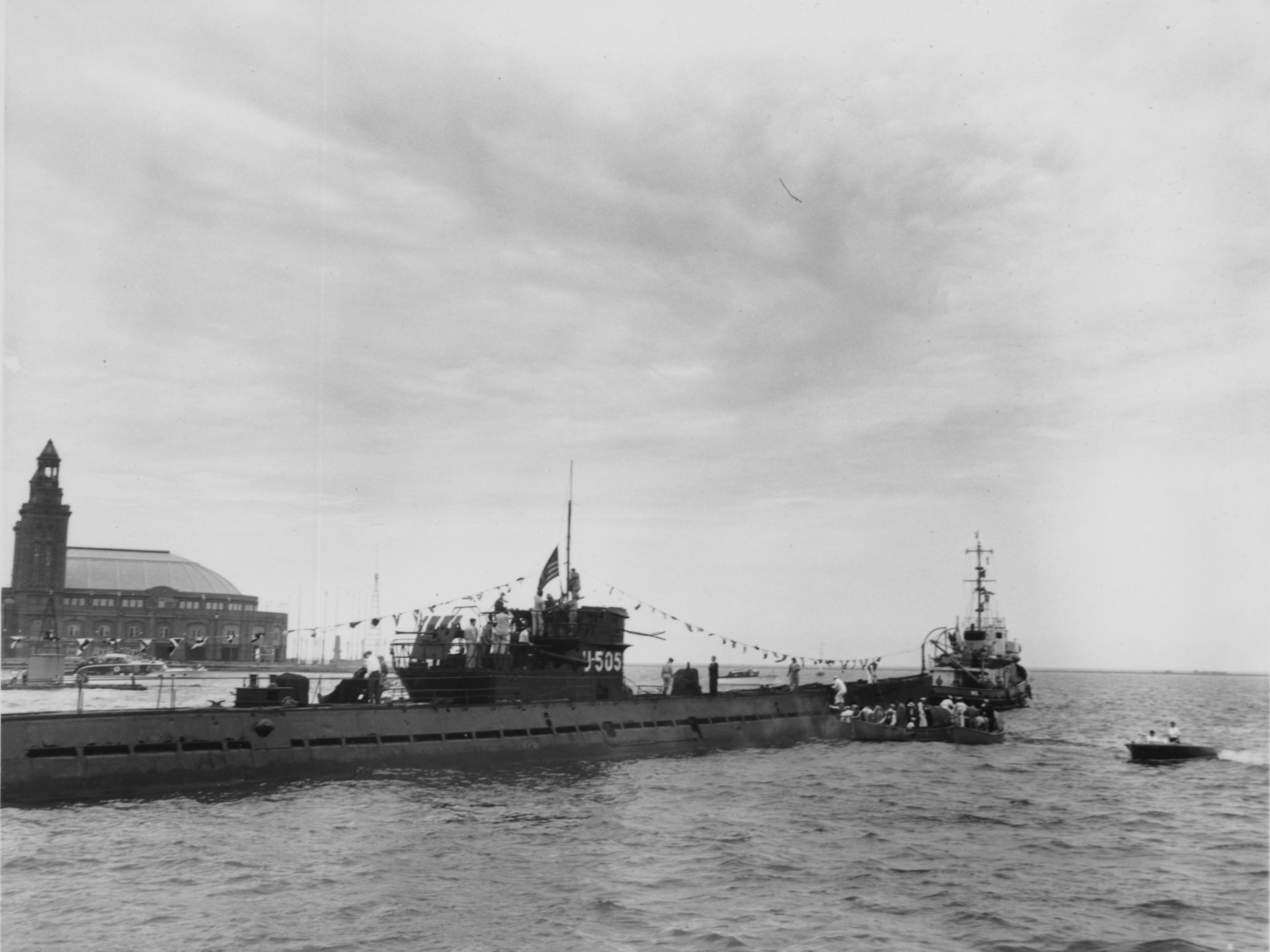 Delegates boarding the captured German U505 submarine as it arrives in Chicago and makes its way to the arrival ceremony to be held on the beach outside the Museum of Science and Industry on June 6, 1954.