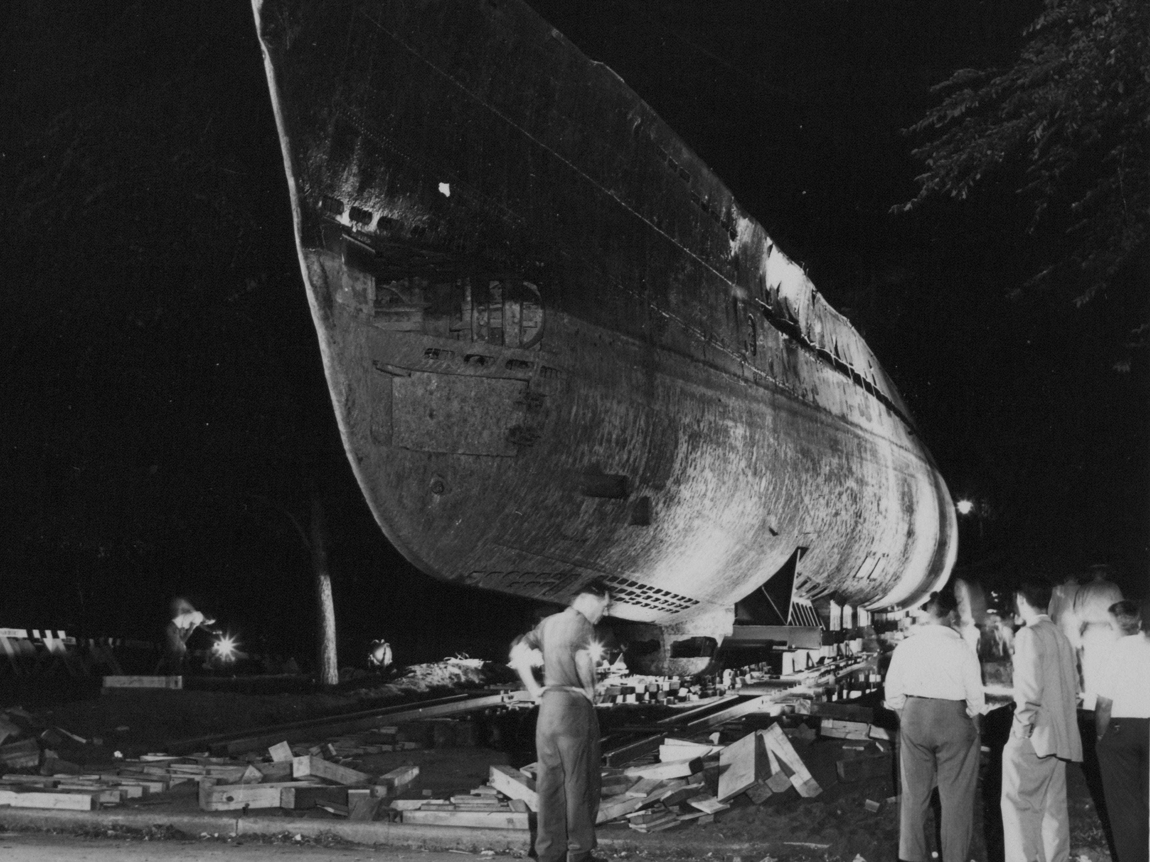 Workers prepare to move the captured German submarine U-505 across Lake Shore Drive in Chicago to its new home at the Museum of Science and Industry.
