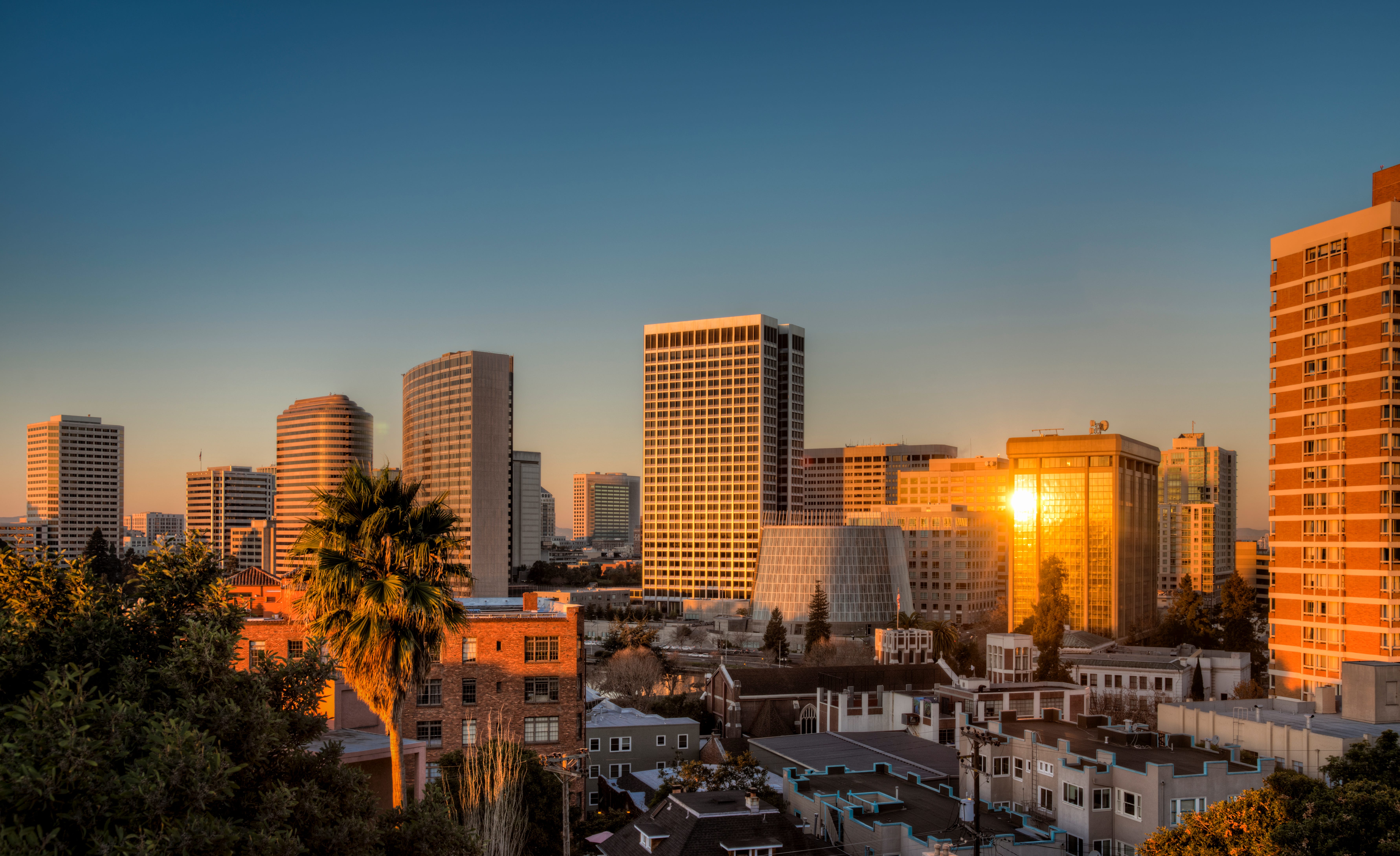 The sun rising and reflecting on buildings in downtown Oakland, California.