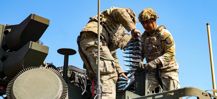 U.S. Army Cpl. Alain Joseph Adona, and Sgt. Jesse Bailon load 30mm ammo into the Stryker variant gun systems before entering a live fire range near Osku, Hungary, June 19, 2025.