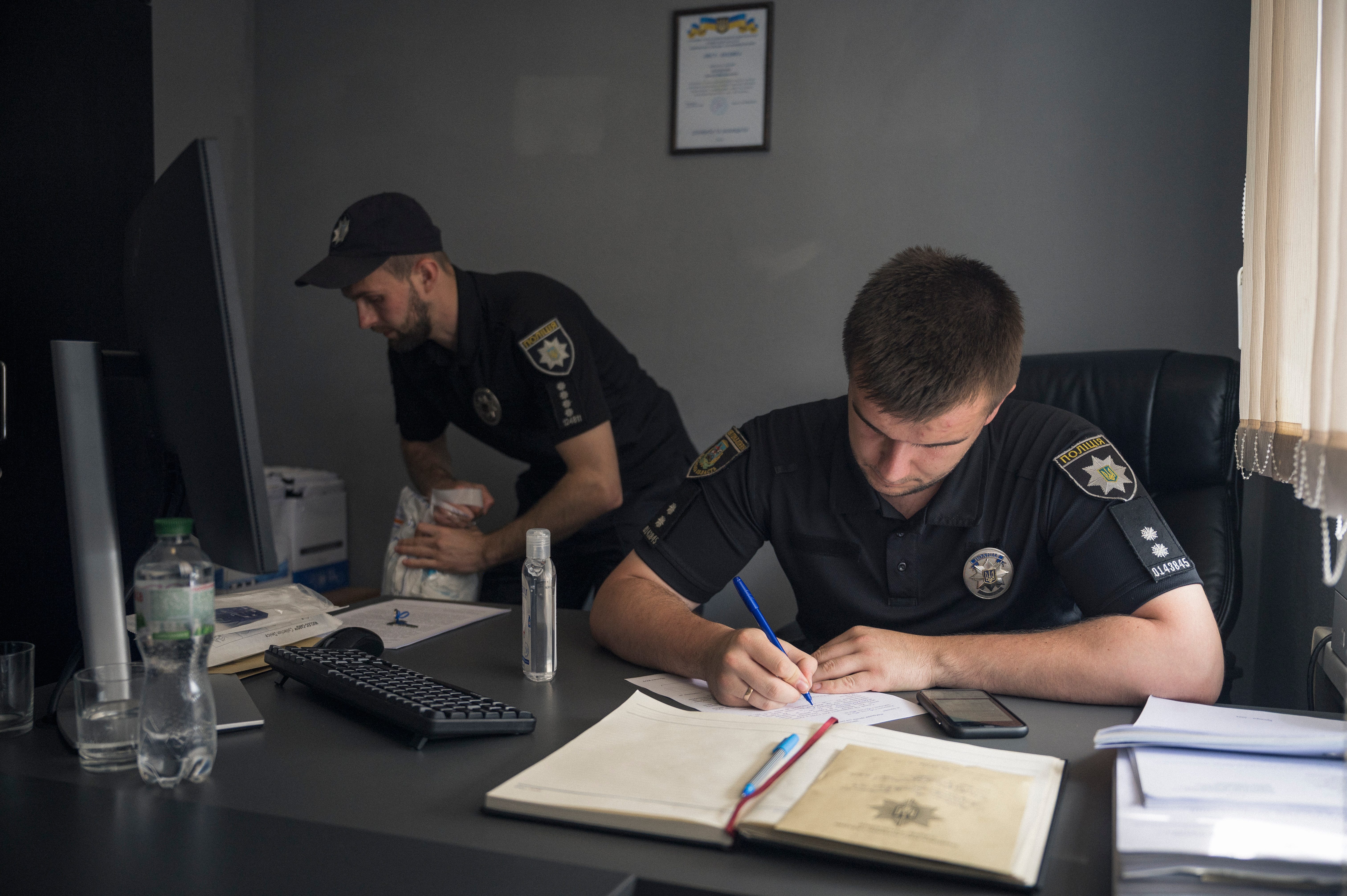 Maksym Kot records a DNA sample taken from Nadia (declined to give last name) who is searching for her missing father at the Brovary District Police Department of the Main Department of the National Police.