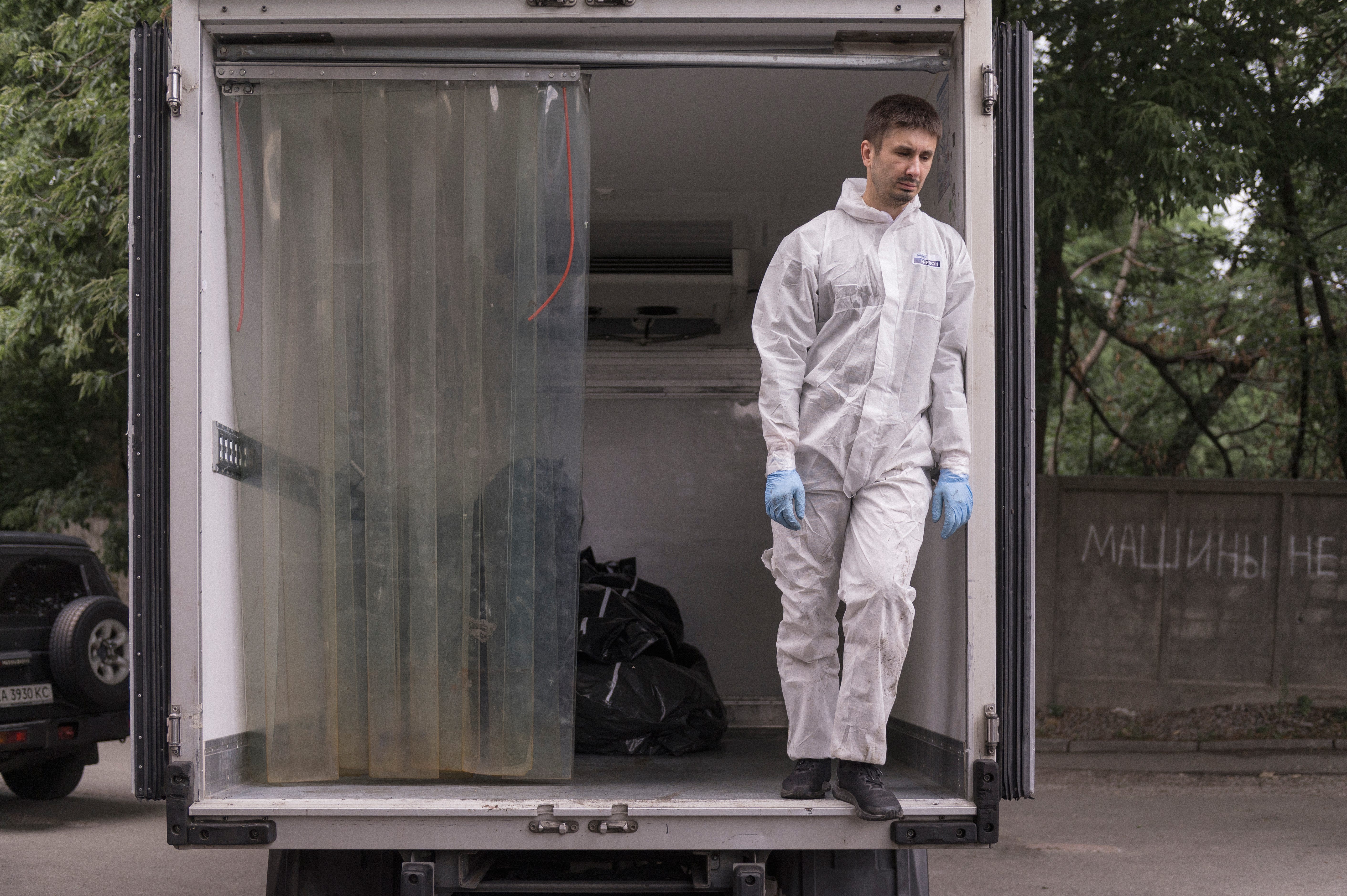 The remains of Ukrainian soldiers killed in action are unloaded from a truck.