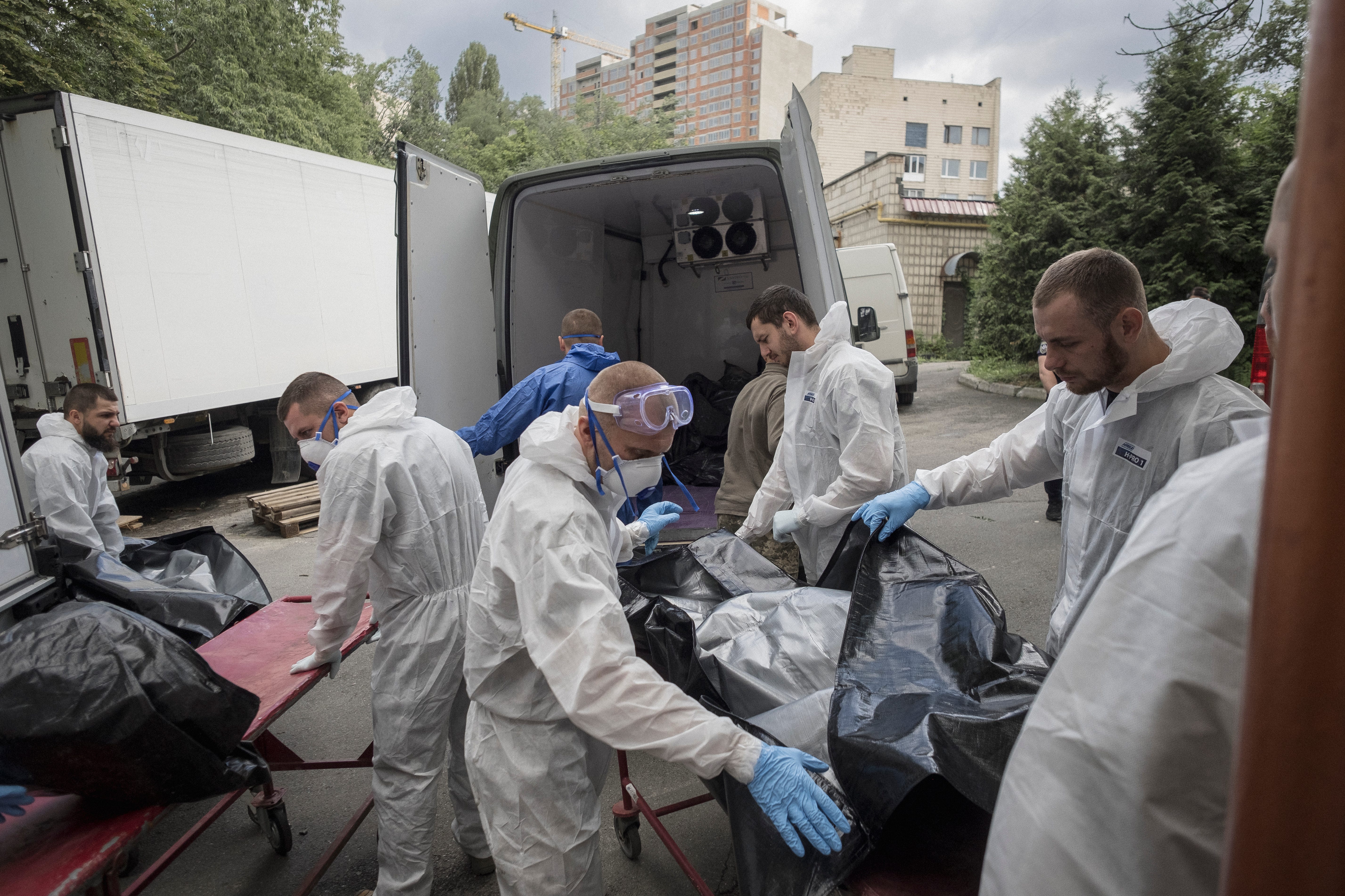 The remains of Ukrainian soldiers killed in action are delivered to a morgue for examination. The bodies were collected by Russian forces and exchanged for Russian bodies at a neutral site after negotiations between the two countries.