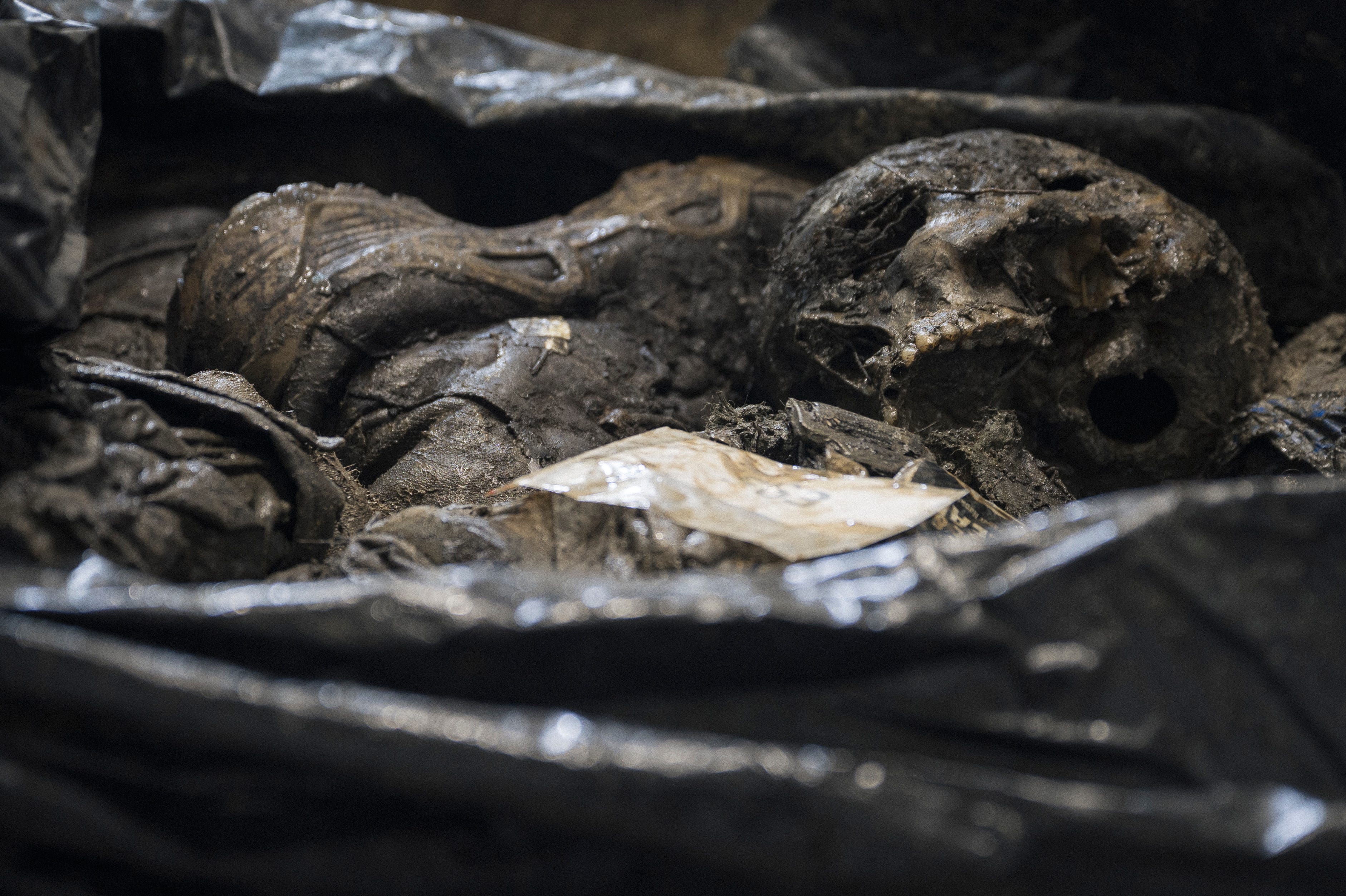 Forensic experts examine the remains of a Ukrainian soldier whose body was returned to the country in an exchange with Russian occupation forces.