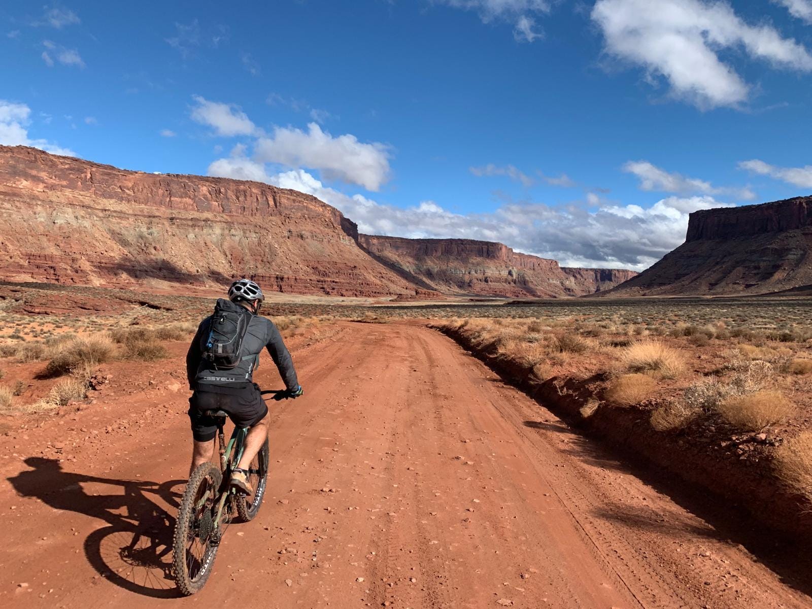 a man mountain biking through the desert