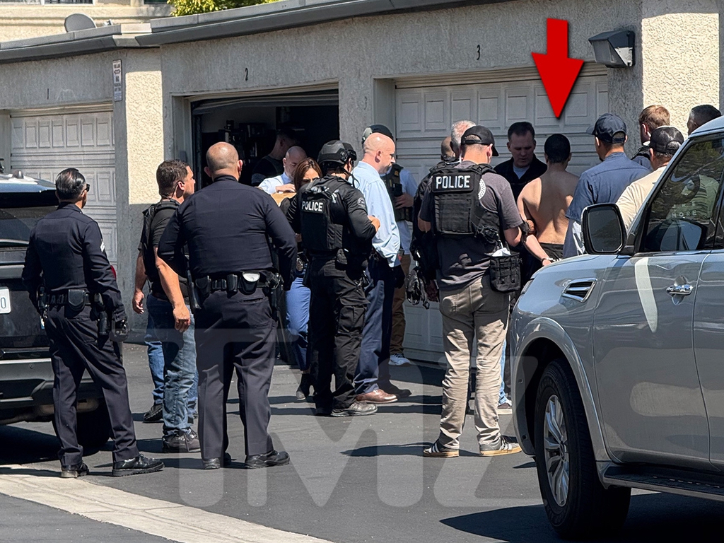 The photos show 22-year-old Raymond Boodarian standing in front of a row of garages at a residential complex, with numerous cops surrounding him.