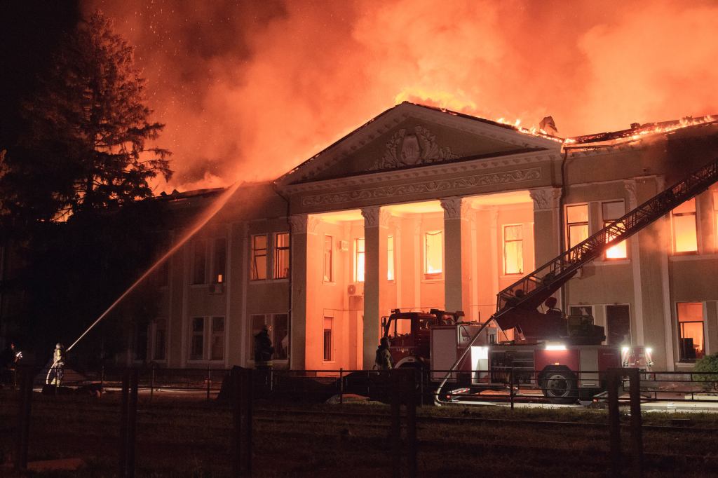 Firefighters battling a fire at a building in Kharkiv, Ukraine, following a drone attack.
