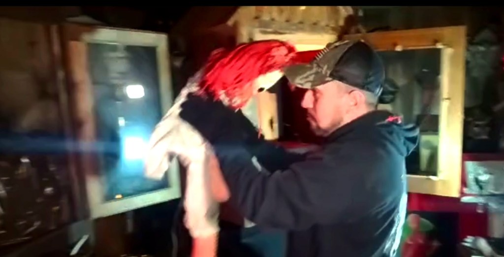 Paranormal investigator Dan Rivera holding the Annabelle doll.