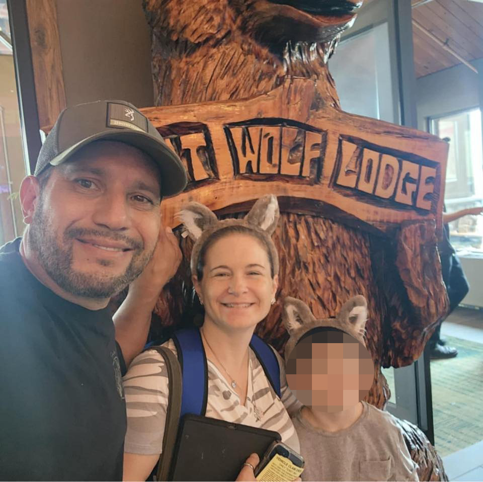 Dan Rivera, Sarah Bond Rivera, and their child at a wolf lodge.