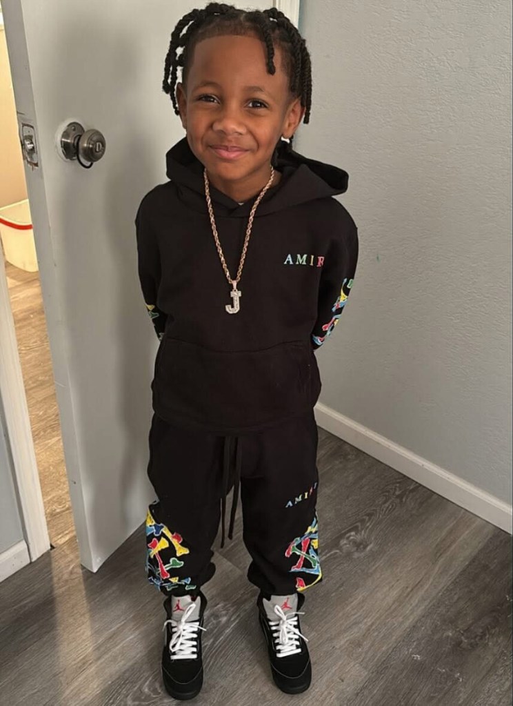 Seven-year-old Jamal White, wearing a black hoodie and sweatpants.