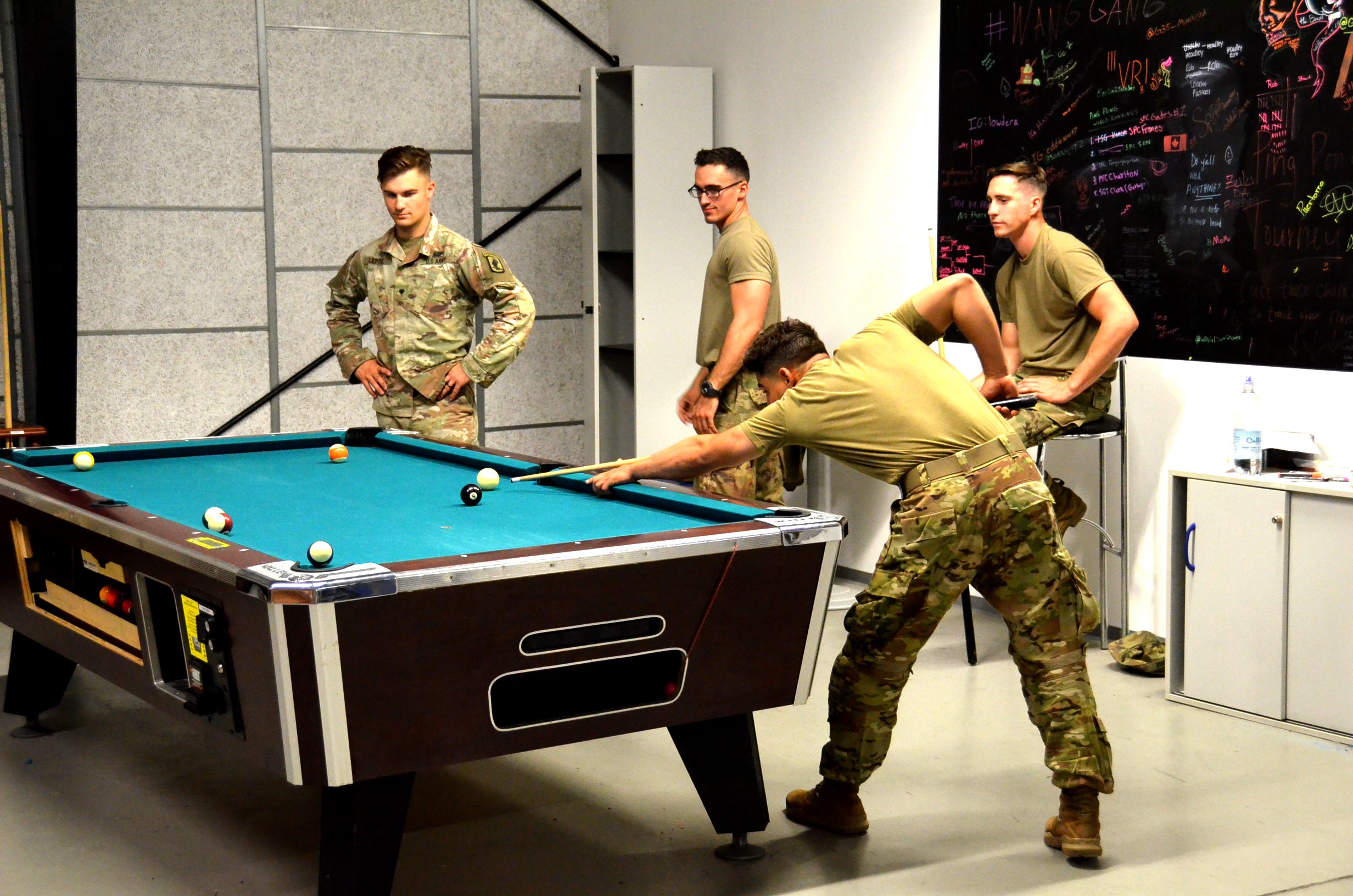 Soldiers with the 173rd Airborne Brigade play a game of pool in the Rhine Ordnance Barracks Deployment Processing Center Sept. 17, 2019.