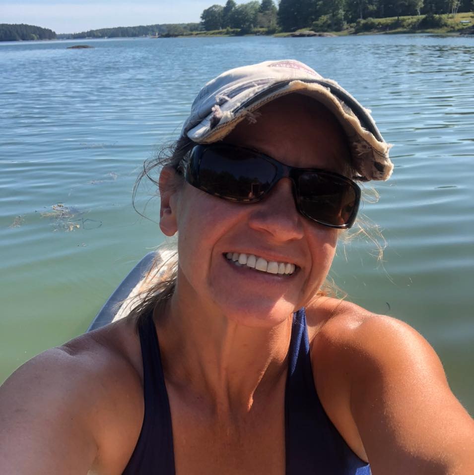 Close-up selfie of a woman on a paddleboard.