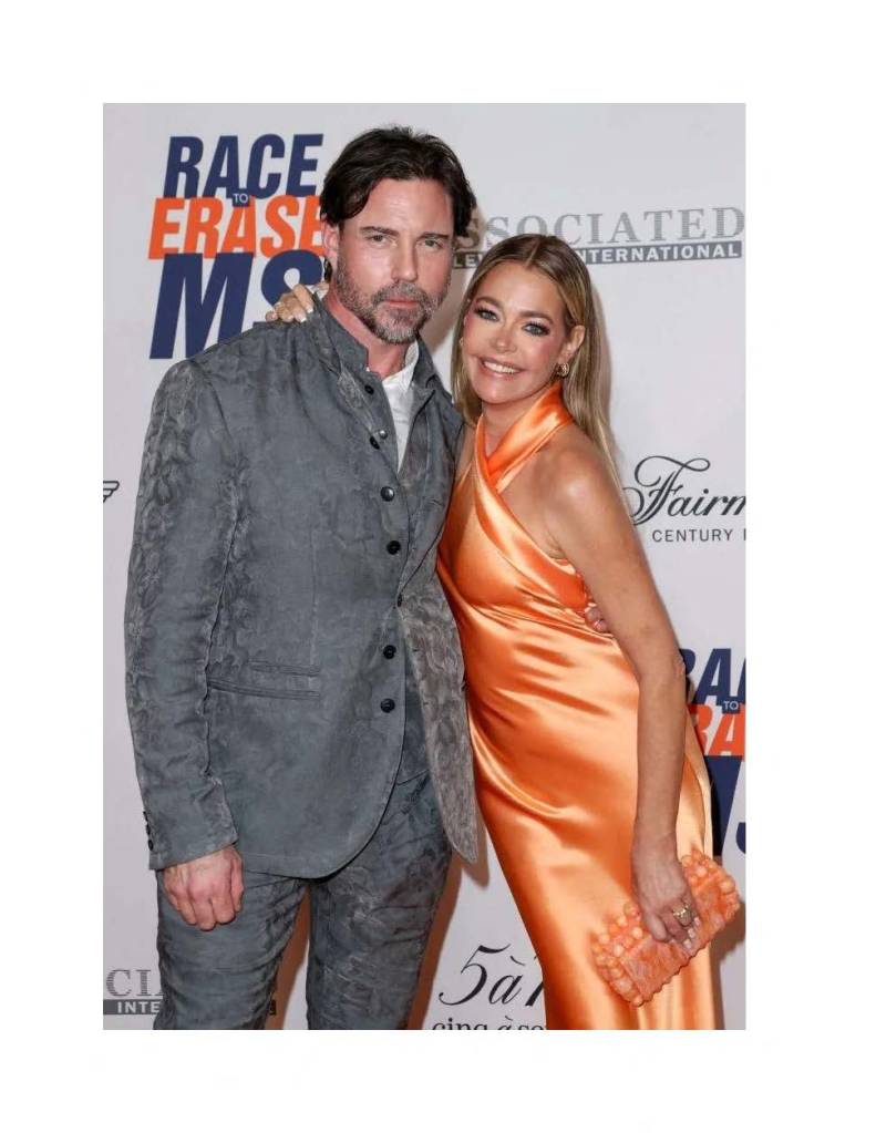 Denise Richards and Aaron Phypers posing on a red carpet.