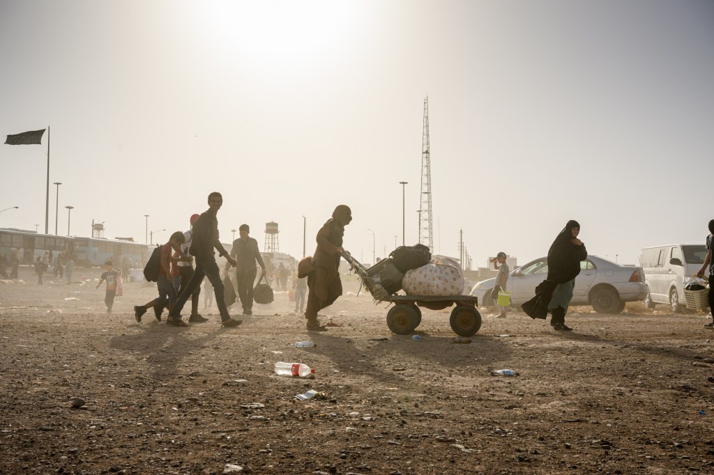 Returnees cross the border from Iran, on July 3, 2025 in Islam Qala, Afghanistan.
