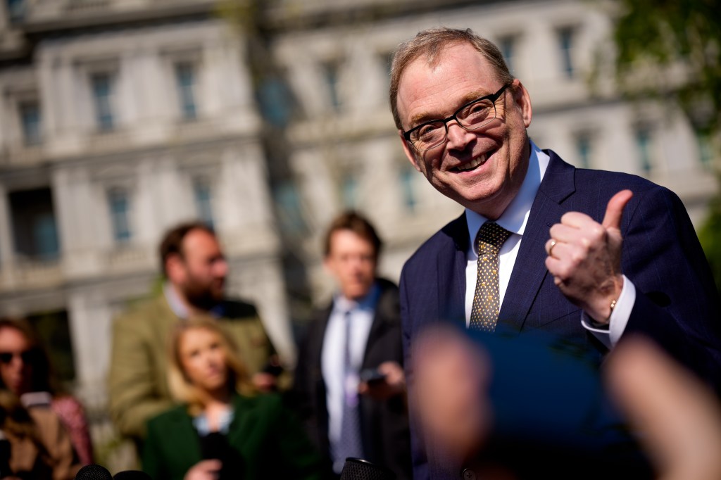 Kevin Hassett giving a thumbs up while speaking to reporters outside the White House.