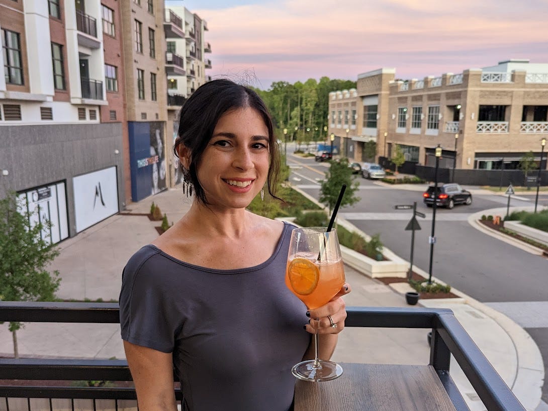 The writer holding a drink outside in North Carolina.