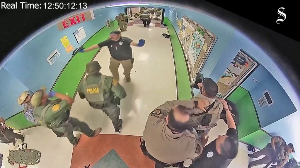 Surveillance video still image of law enforcement officers responding to the Robb Elementary School shooting.