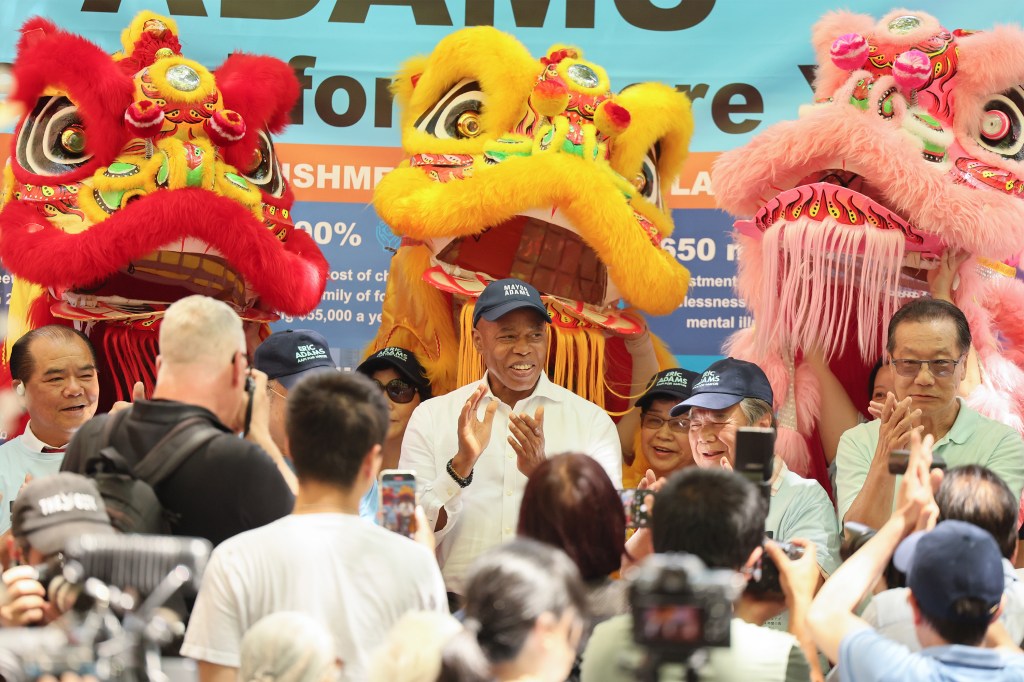 Mayor Eric Adams at a campaign event with lion dancers.