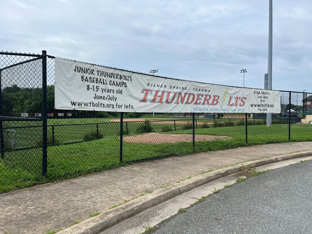 Banner advertising Junior Thunderbolts baseball camps for 8-15 year olds in June and July.