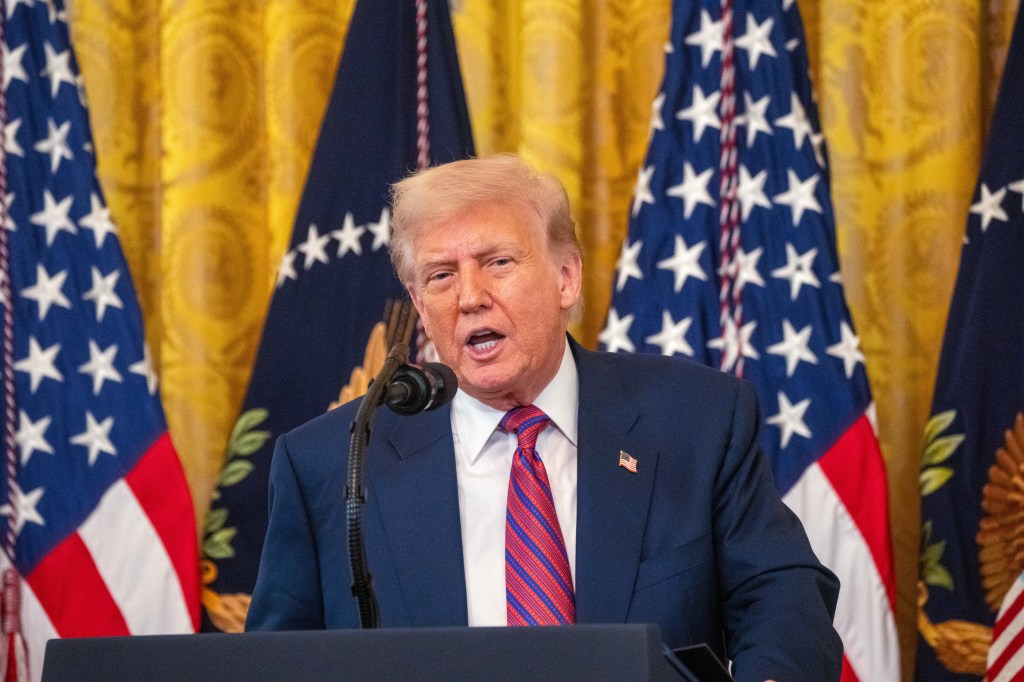 Donald Trump speaking at a podium in the White House.