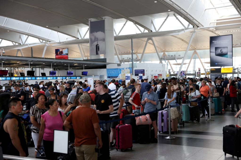 Passengers waiting in line at an airport check-in.