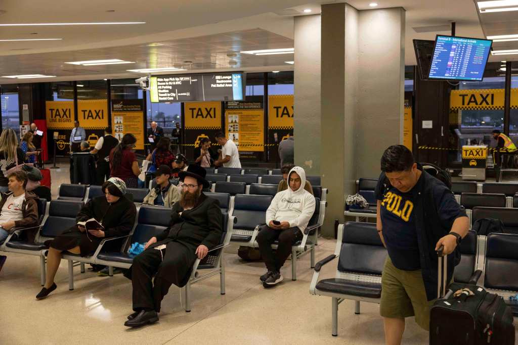 People waiting in an airport terminal.