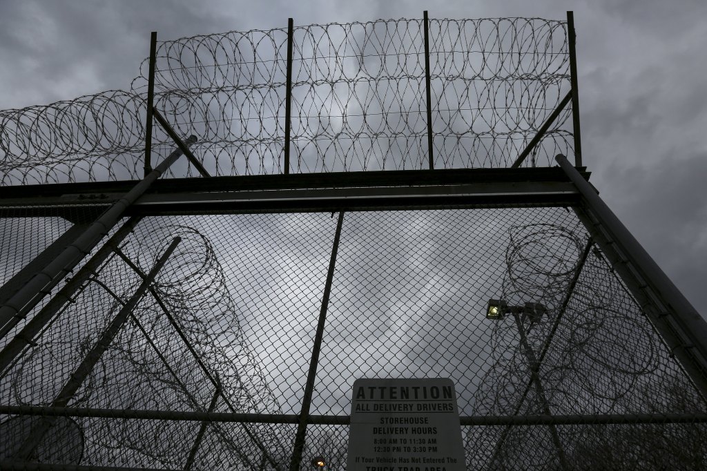 Razor wire atop a chain-link fence at a correctional facility.