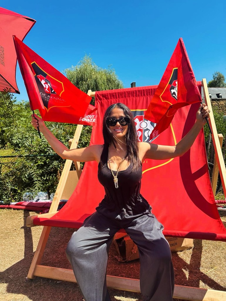 Salma Hayek takes a giant seat while cheering on the riders in the Tour de France during a stage visit to Treverien in Brittany.