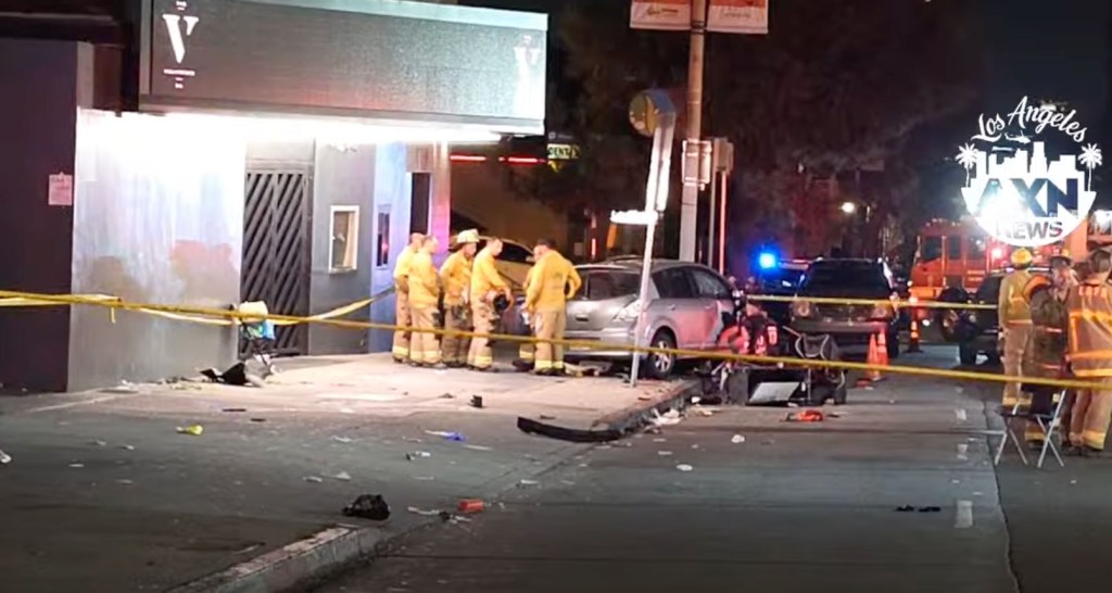 Aftermath of a car crash into a crowd, with first responders on scene.
