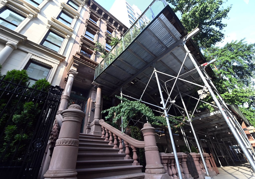 a view of the front stoop of 41 east 72nd with scaffolding over the front