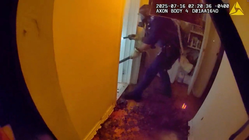 NYPD officers rescuing people from a burning building.