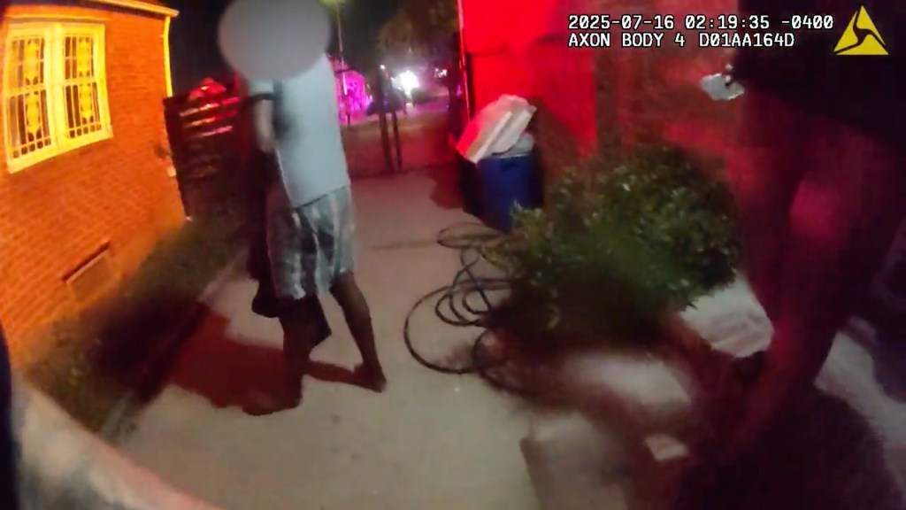 Video still showing NYPD officers rescuing people from a burning building.
