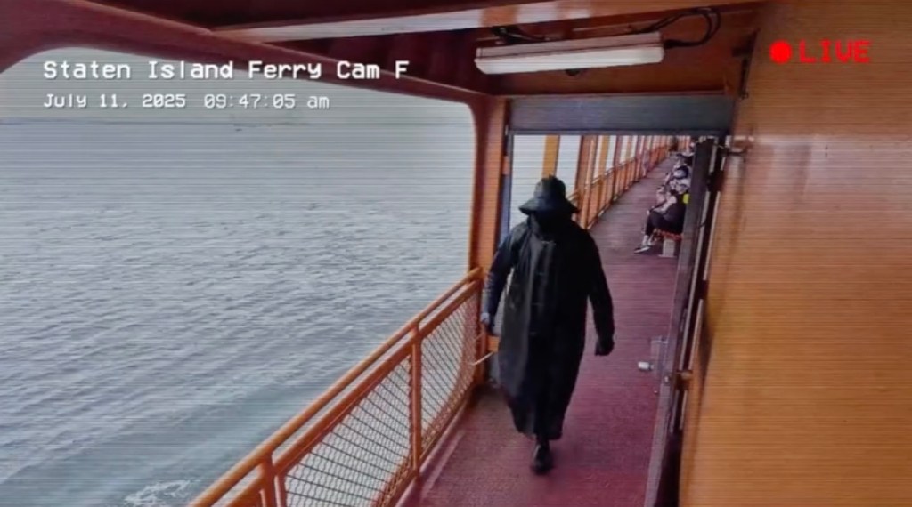 Screenshot from surveillance video showing mysterious cloaked man, carrying a sickle, hanging out on the Staten Island Ferry