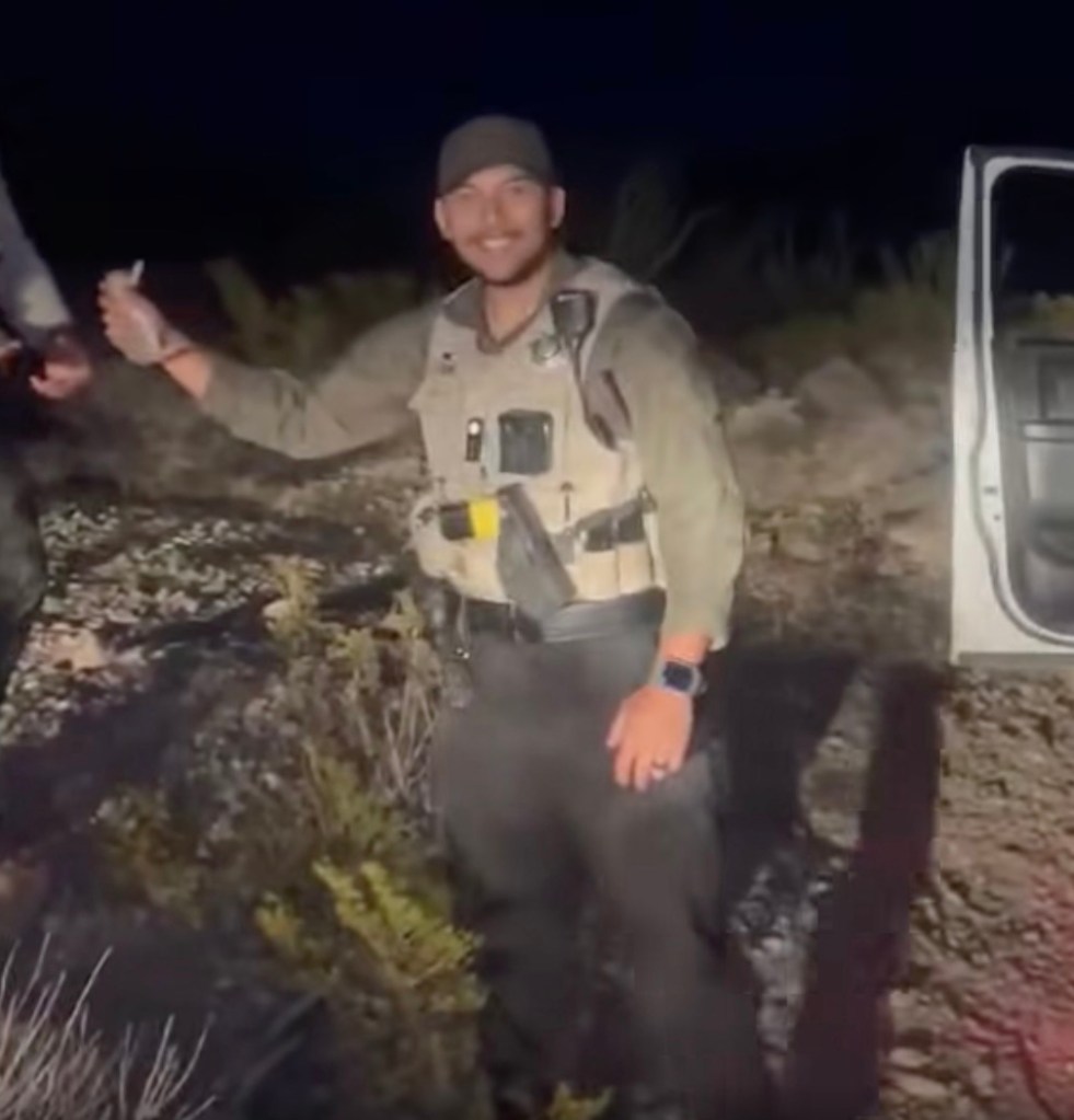 Deputy Alejandro Gomez placing a baby bunny in a vehicle.