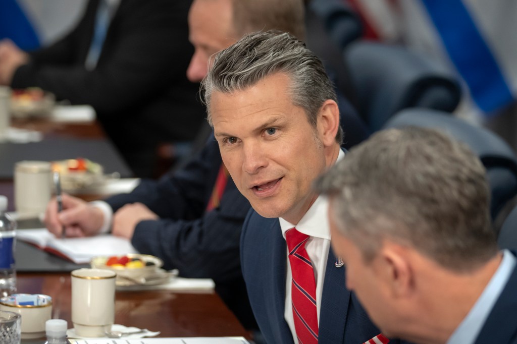 Pete Hegseth speaking at a meeting.