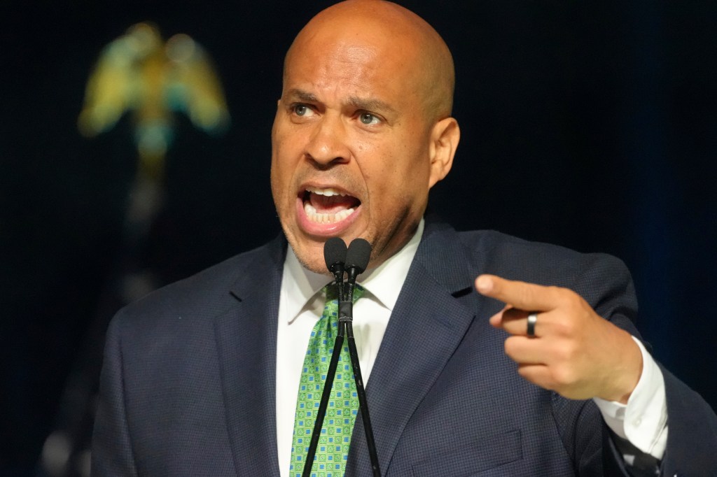 Cory Booker speaking at a podium.