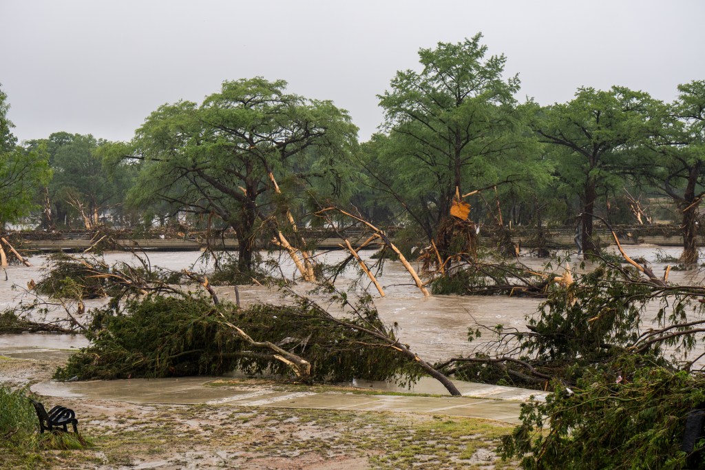 Reporters and camera crews at a flood-damaged site in Texas.