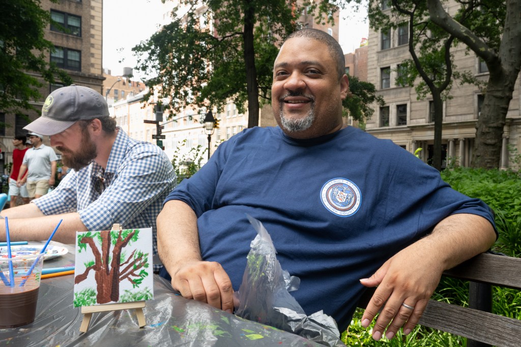 Manhattan District Attorney Alvin Bragg at an Art of Healing event, painting a tree.