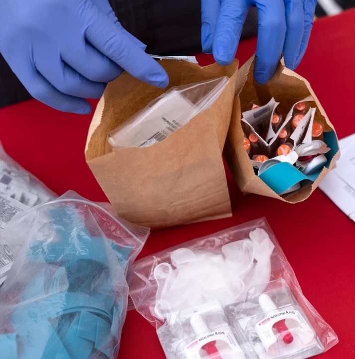 Harm reduction kit contents in paper bags and plastic bags.