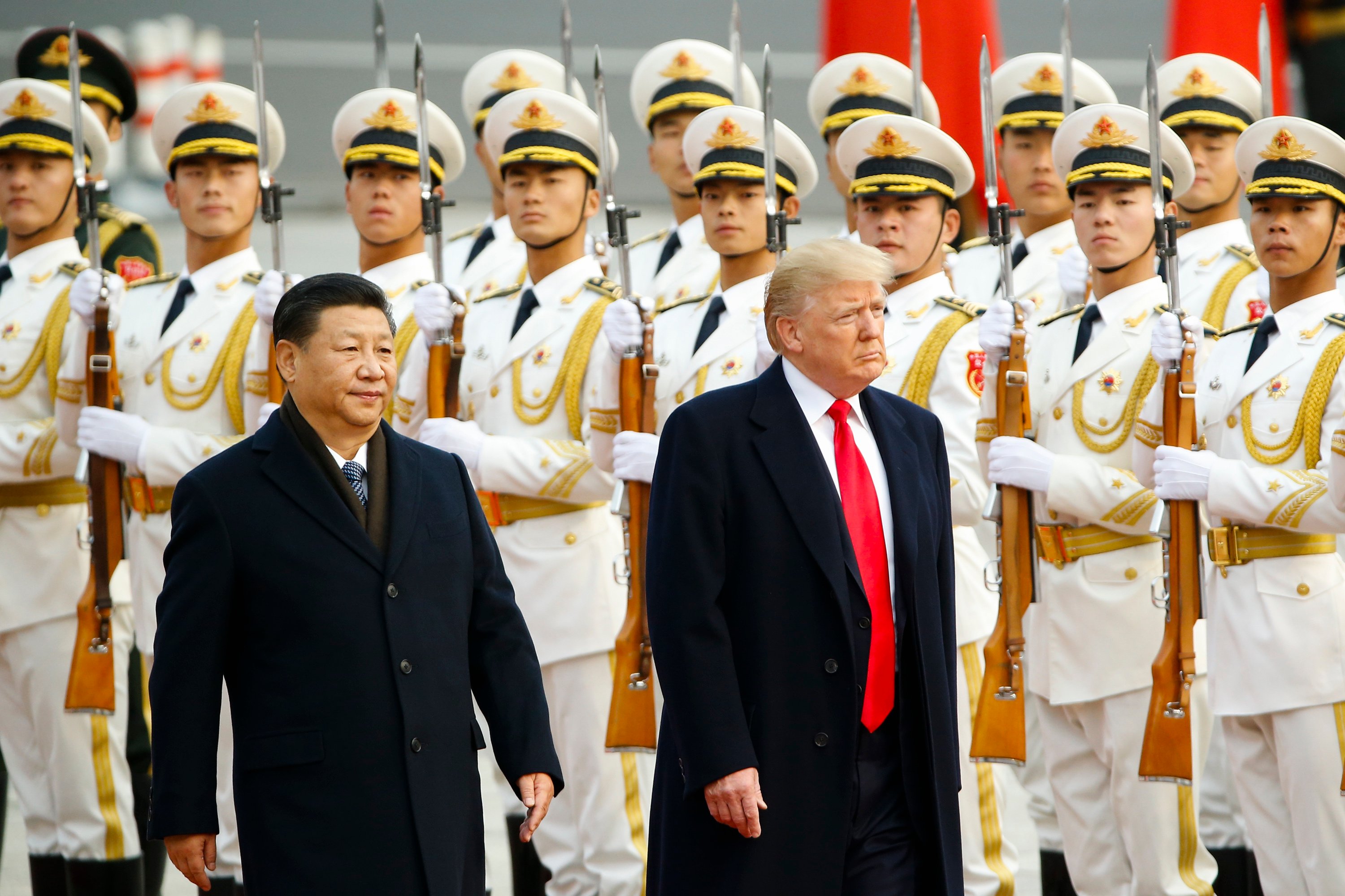 Xi and Trump walk side by side.