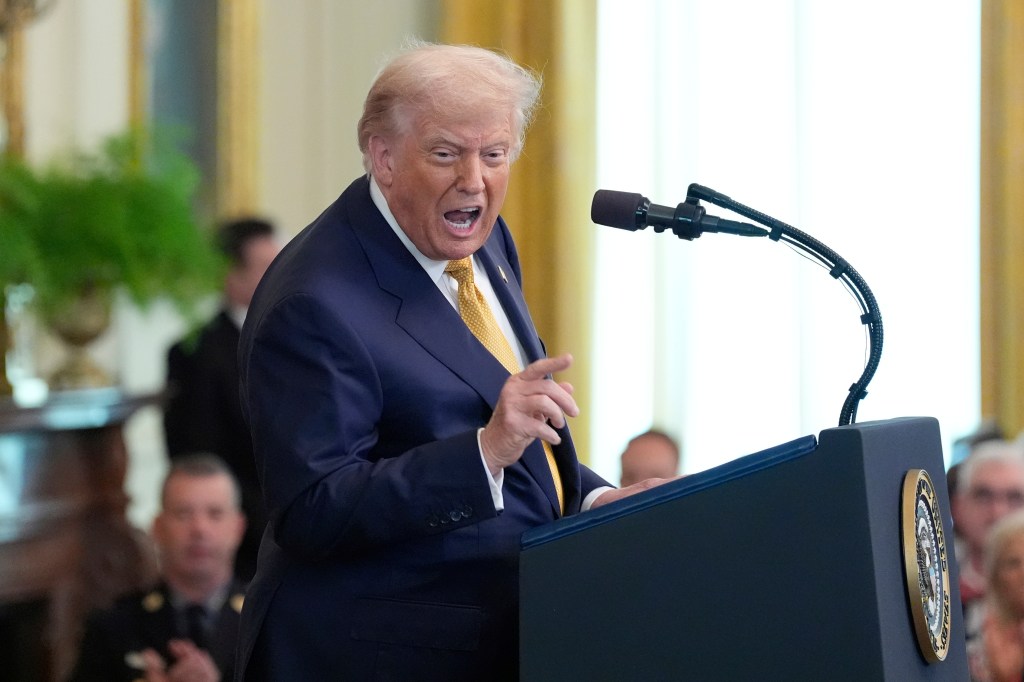 Donald Trump speaking at a podium.