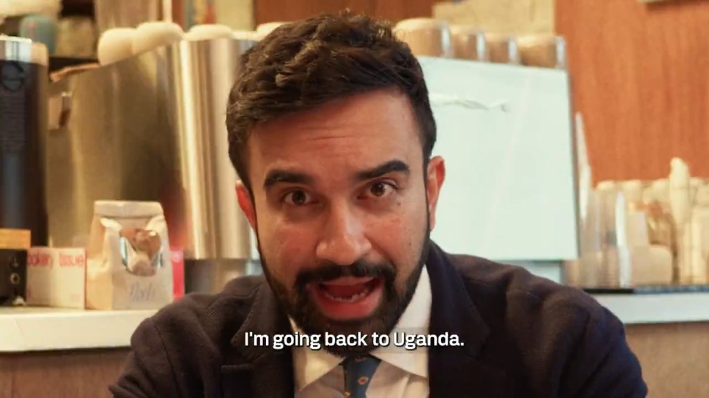 Man in suit announcing his return trip to Uganda.
