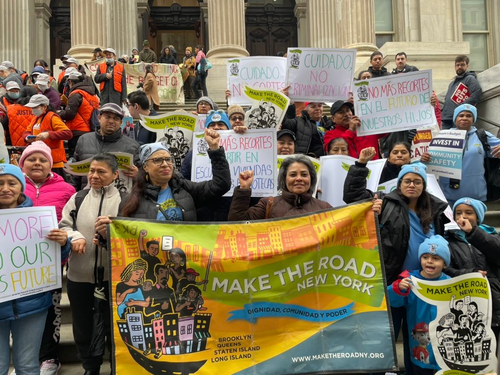 Protestors holding signs advocating for Make the Road New York.