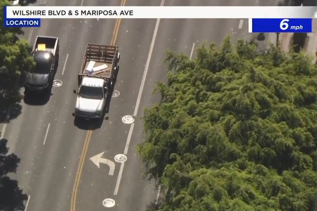 Aerial view of Wilshire Blvd & S Mariposa Ave with two trucks moving at 6 mph.