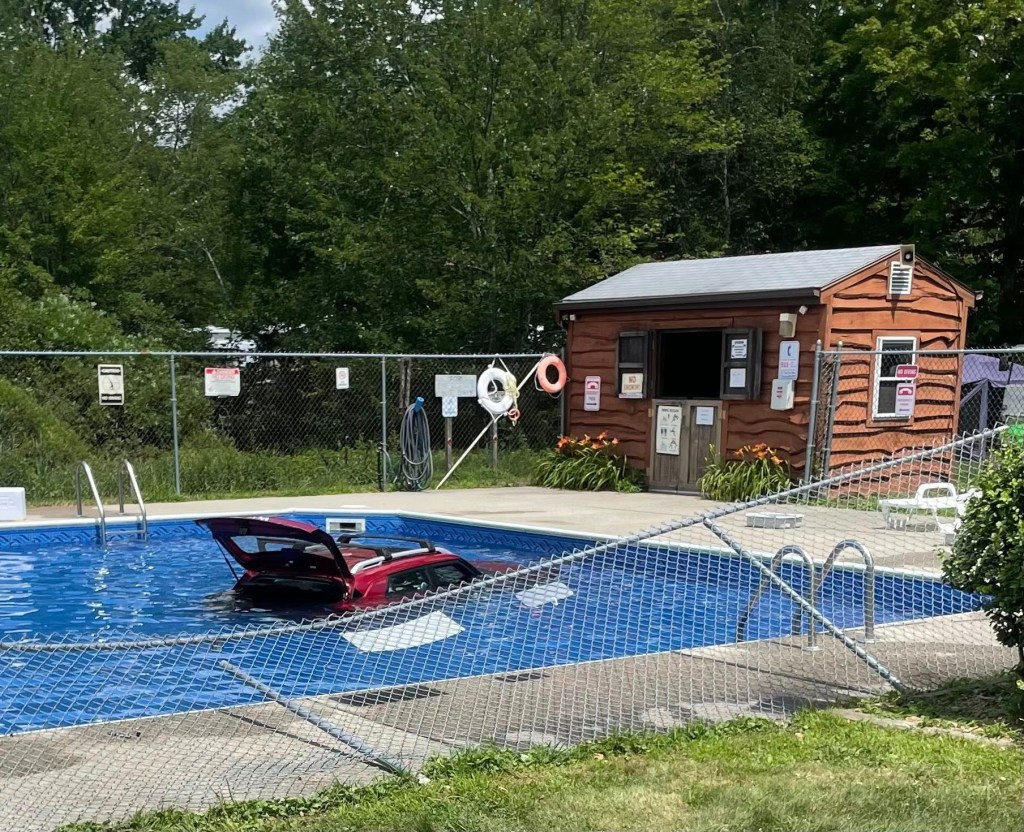 Car submerged in a swimming pool.